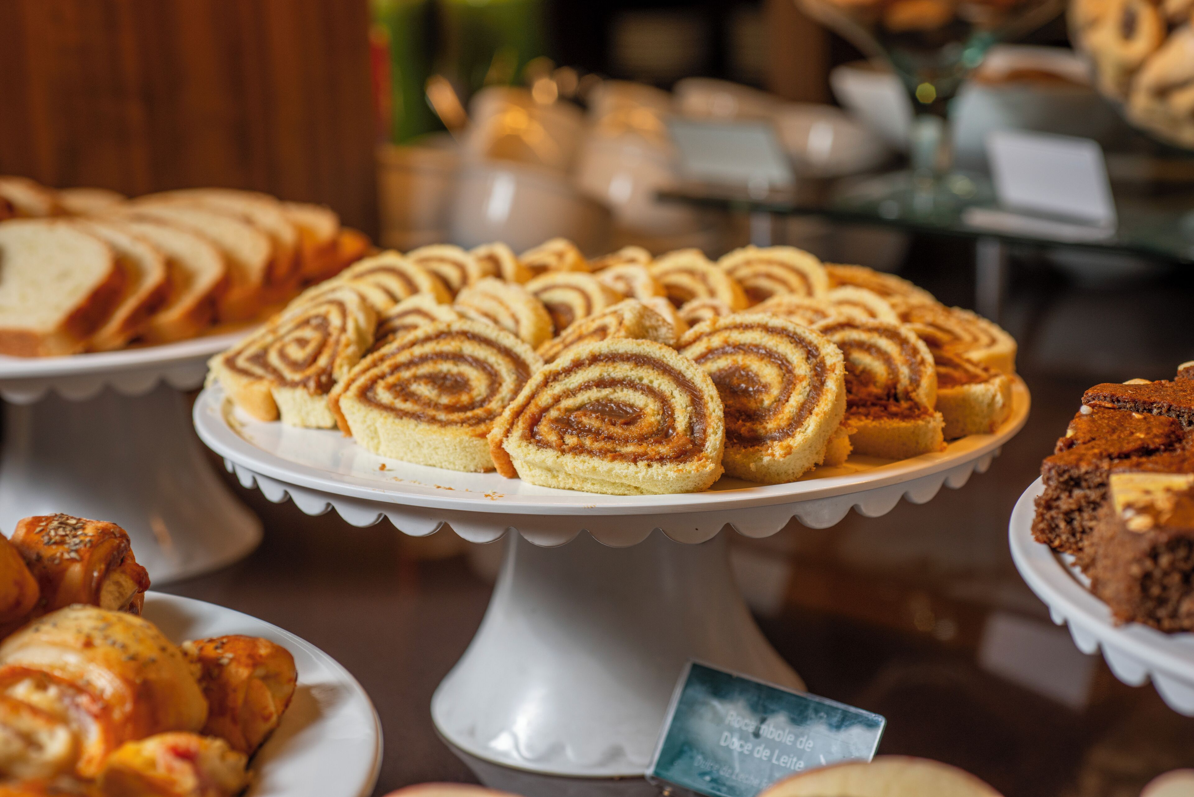 A variety of pastries on a white cake stand.
