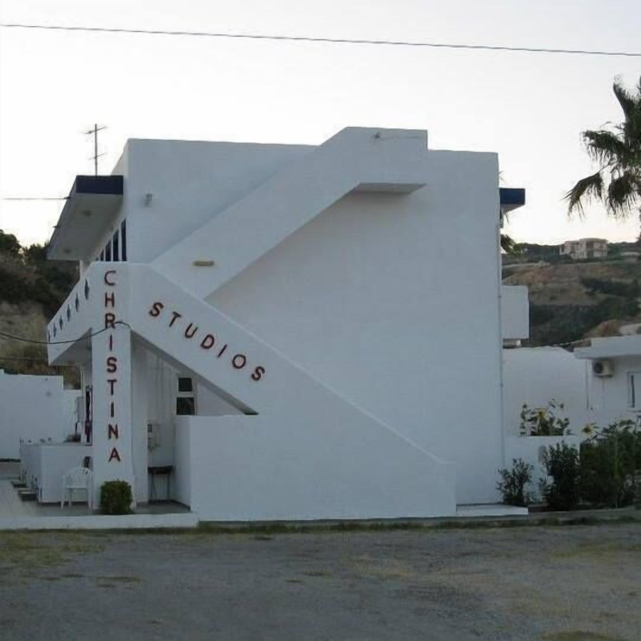 A modern white building with the name "CHRISTINA STUDIOS" on the side.