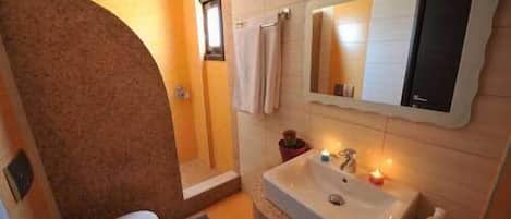 A bathroom with a bathtub, a toilet, and a sink.