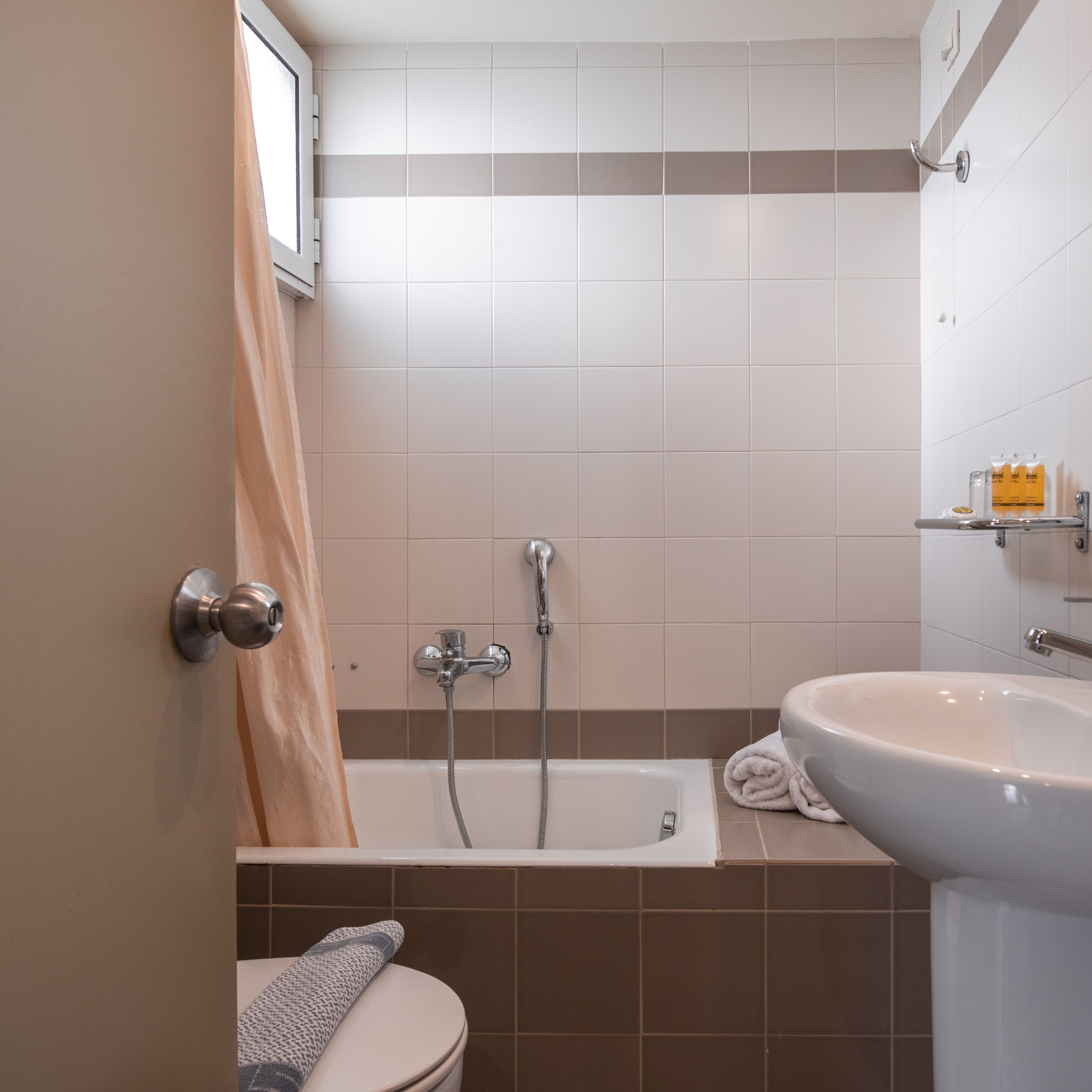 A bathroom with a bathtub, a sink, and a toilet.