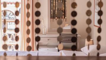 A bedroom with a bed, a dresser, a mirror, and a lamp.