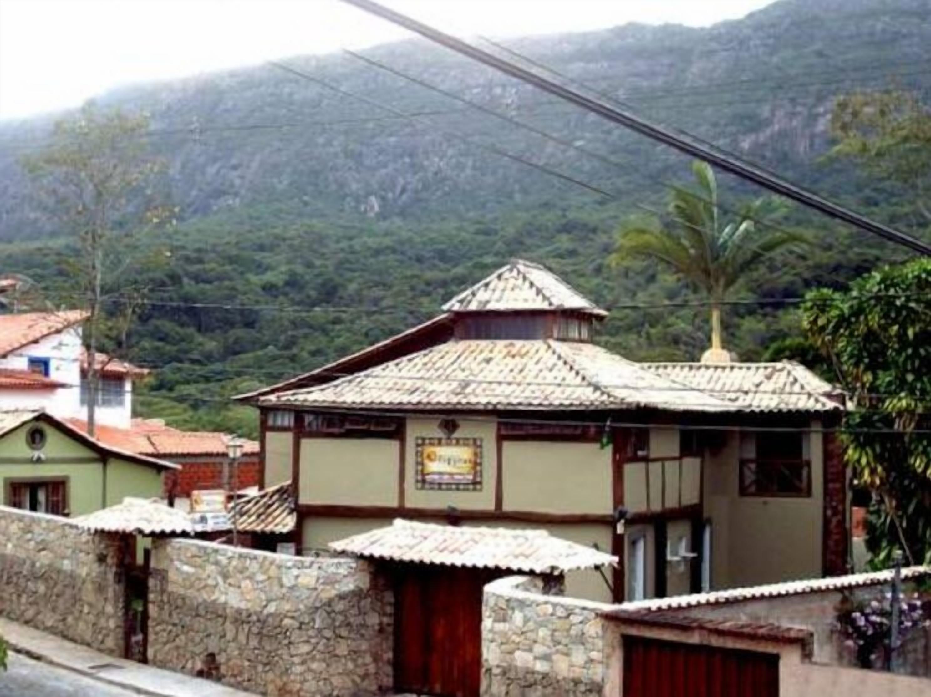 A traditional building with a tiled roof, stone walls, and a small porch.