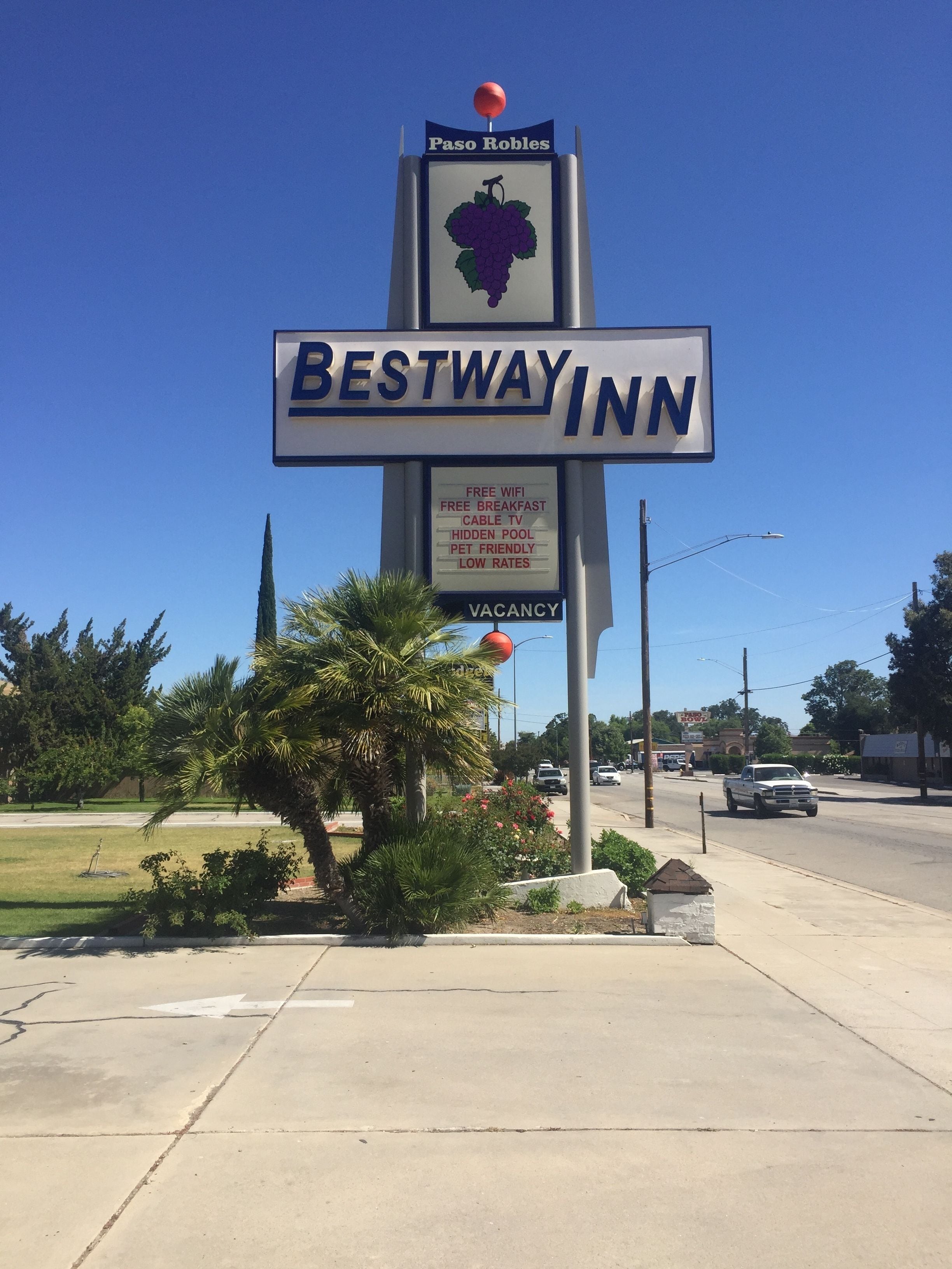 A Bestway Inn sign with amenities listed, including free WiFi, breakfast, cable TV, a hidden pool, pet-friendly, and low rates.