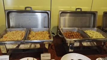 A buffet with labeled food items including fried rice, fried noodles, and other dishes.