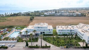A resort with multiple buildings, a swimming pool, and a parking area. - Tropical Sol (Kos)