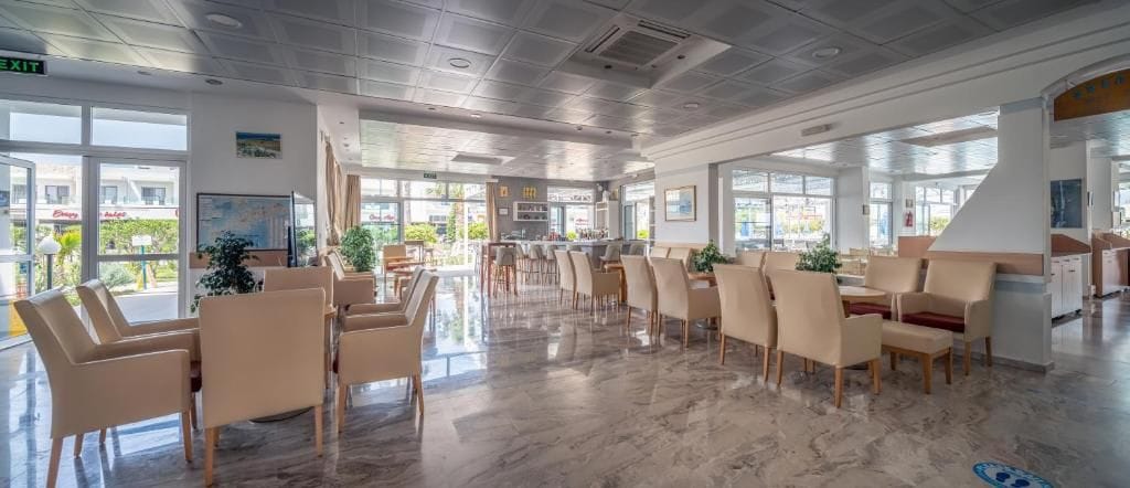 A spacious indoor area with multiple seating arrangements, large windows, and a clean, modern design.