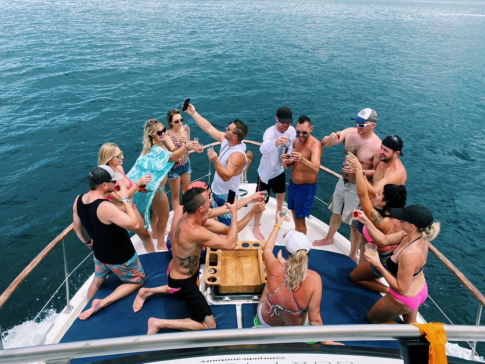 A group of people on a boat with a view of the water.