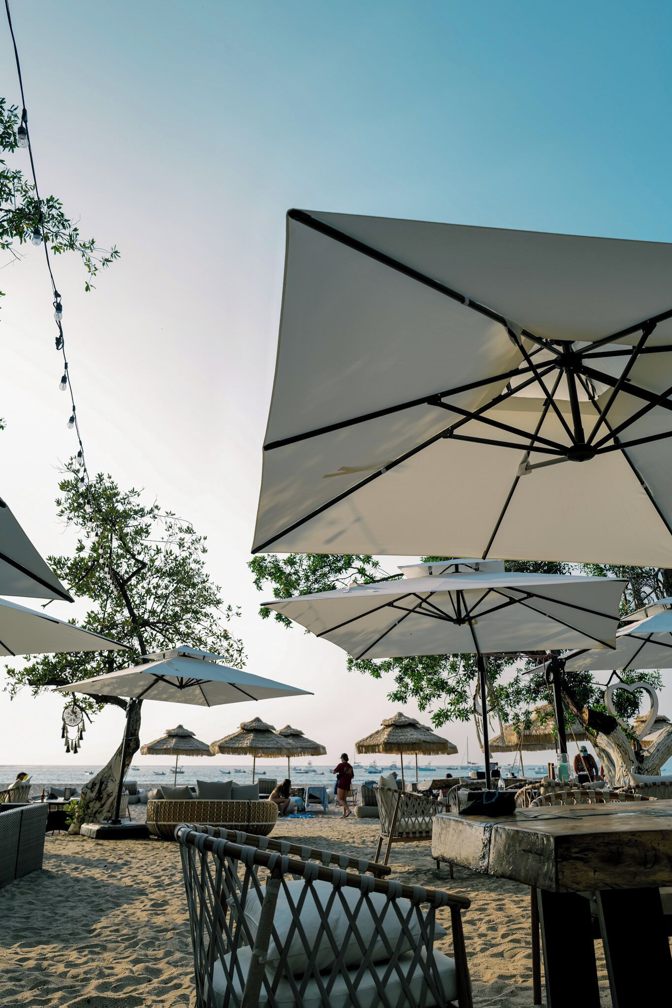 Outdoor seating with umbrellas, beach chairs, and tables.