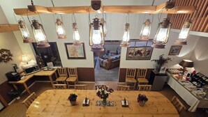 A dining area with a wooden table and chairs, surrounded by lantern-style lighting fixtures. - Buffalo Peaks B&B (Buena Vista)
