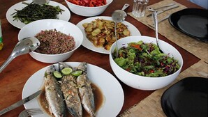 A table with various dishes including fish, vegetables, and salads. - Talalla Bay Beach House (Talalla)