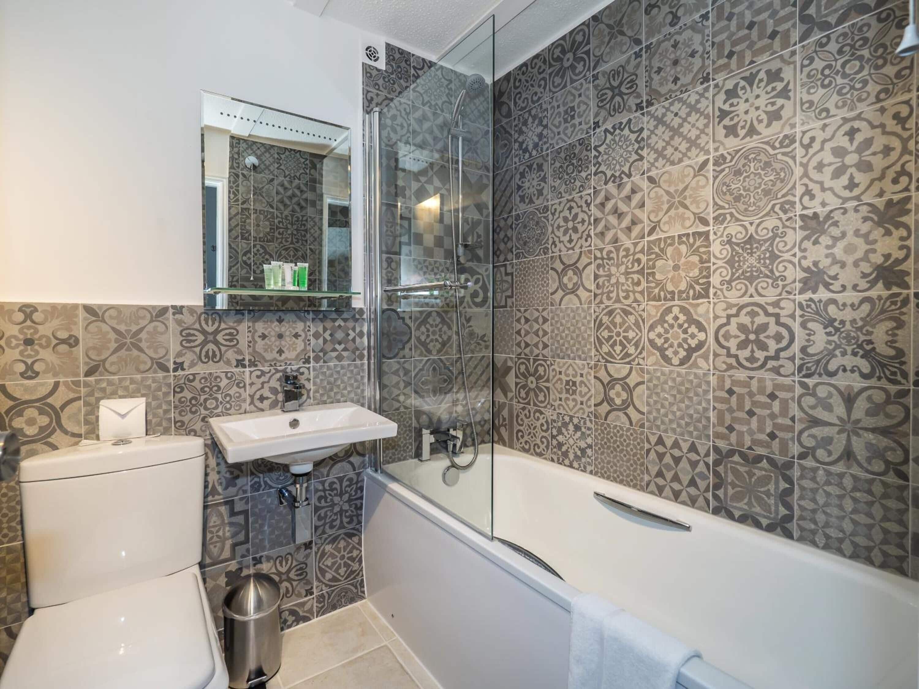 designer toiletries, hair dryer, towels