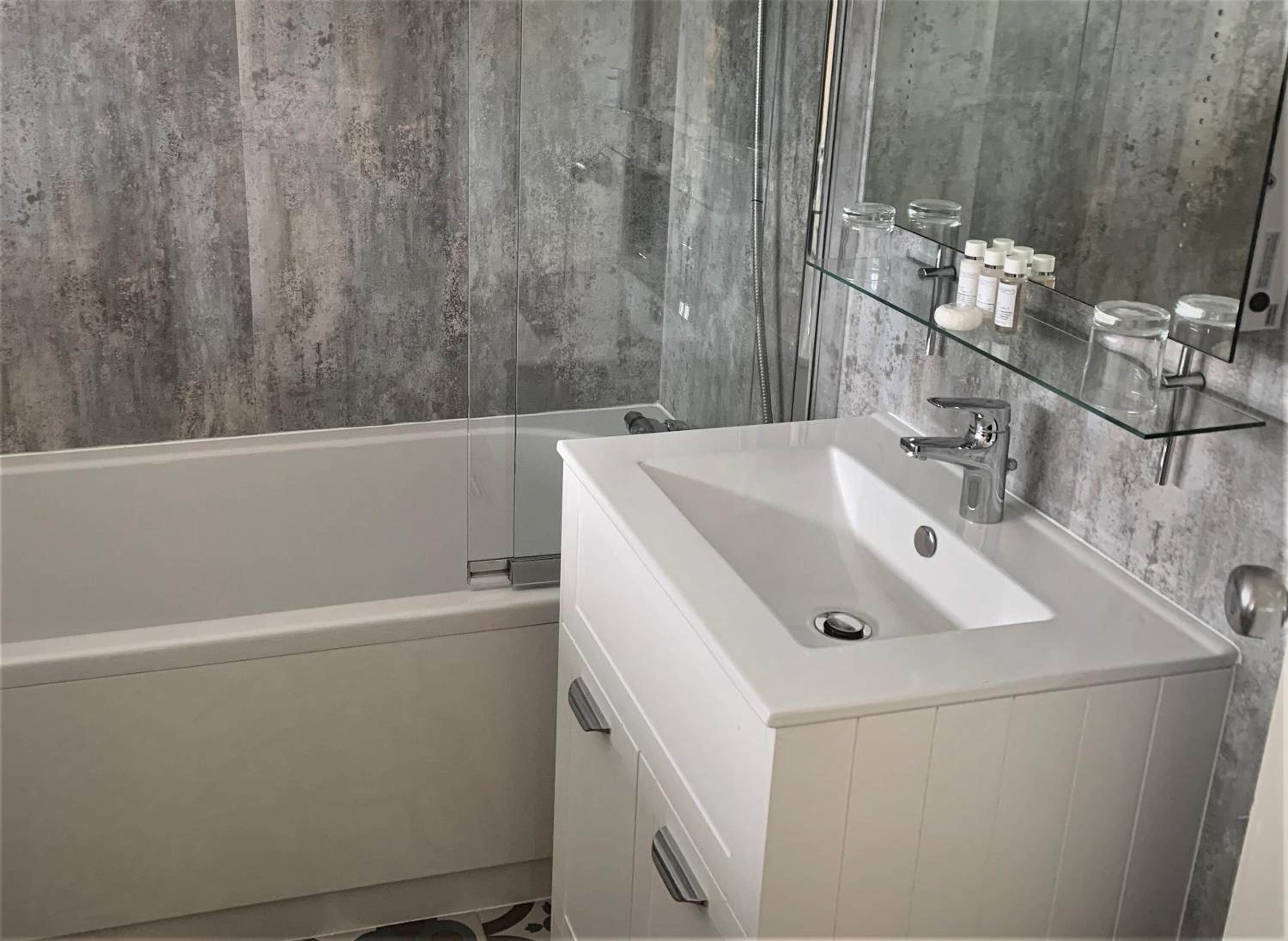 designer toiletries, hair dryer, towels