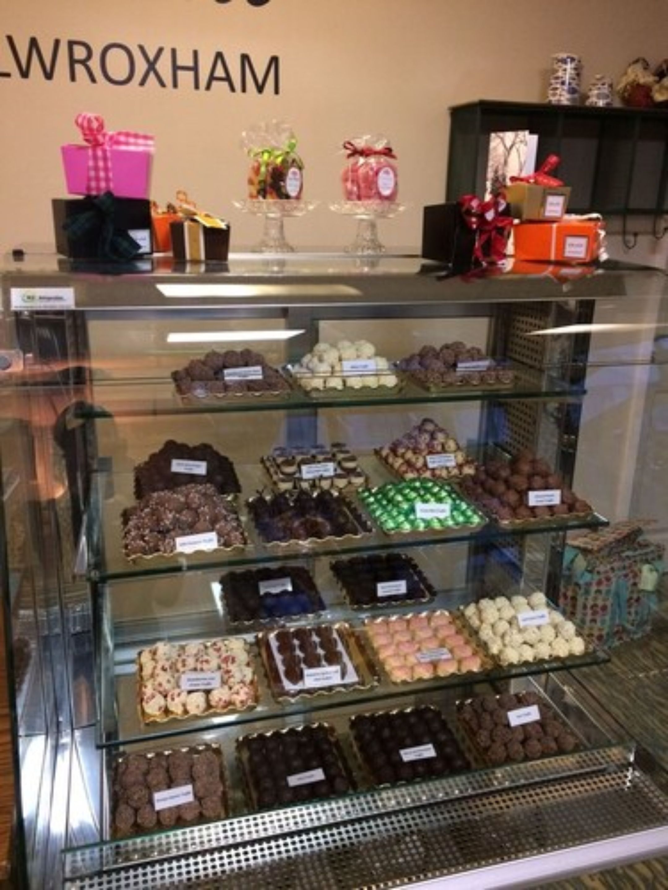 A display case of assorted chocolates and sweets in a store.