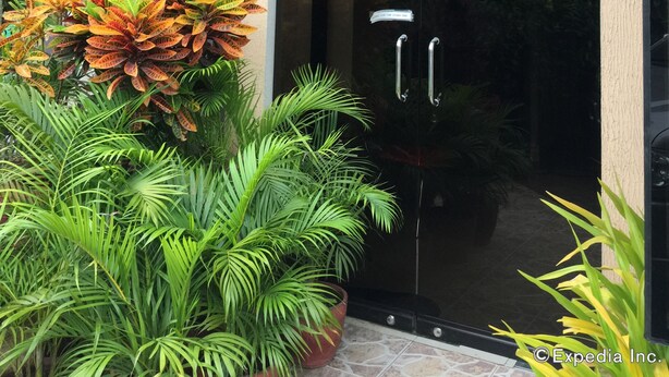 The entrance to Kode Inn with a glass door and a sign above. - Kode Inn (Tagbilaran)