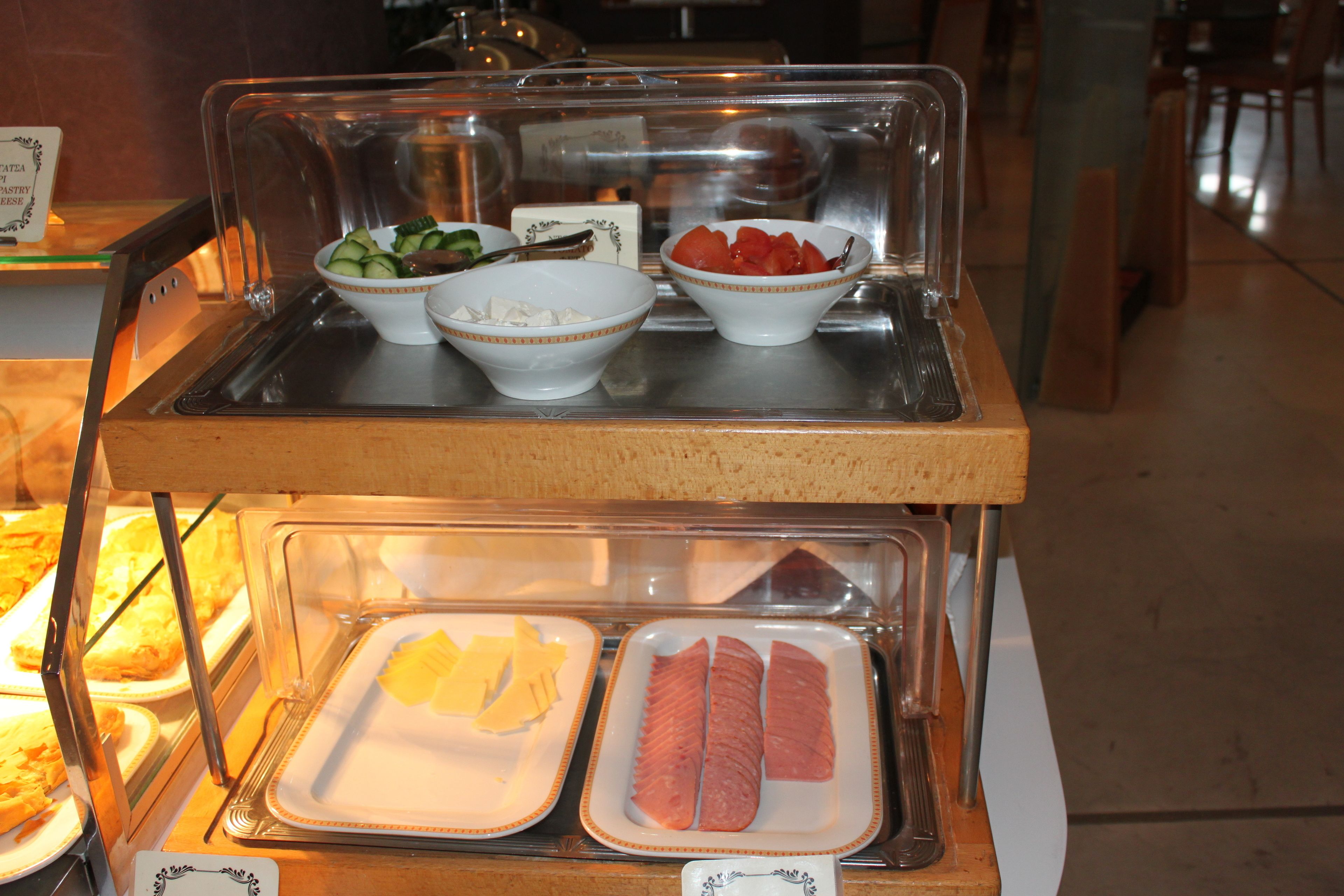 A buffet with various food items displayed in bowls and trays.