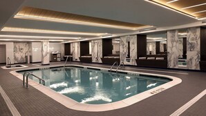 A modern indoor swimming pool with marble walls and a tiled floor. - Montauk Manor (Montauk)