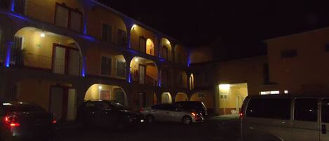 A multi-story building with a courtyard parking area.