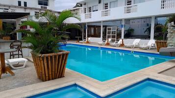 Piscina externa, piscina com cascata, espreguiçadeiras