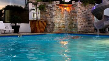 Outdoor pool, a waterfall pool, sun loungers