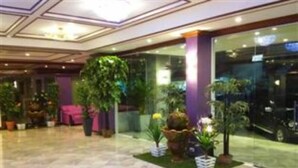 A lobby with a marble floor, potted plants, and a glass entrance. - Merlin Grand Hotel Hat Yai (Hat Yai)