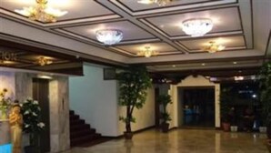 A spacious lobby with a marble floor, a reception desk, and a staircase leading to upper floors. - Merlin Grand Hotel Hat Yai (Hat Yai)