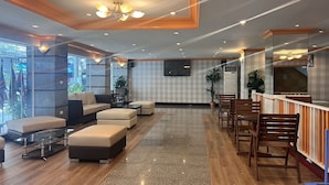 A modern lobby with a reception desk, seating area, and a large screen. - Asia Grand Hotel Hat Yai (Hat Yai)