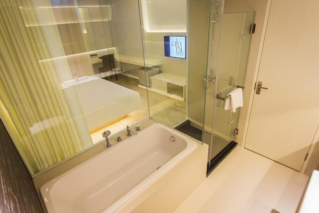 Een moderne badkamer met een douchecabine van glas, een bad en een verzorgingsruimte.