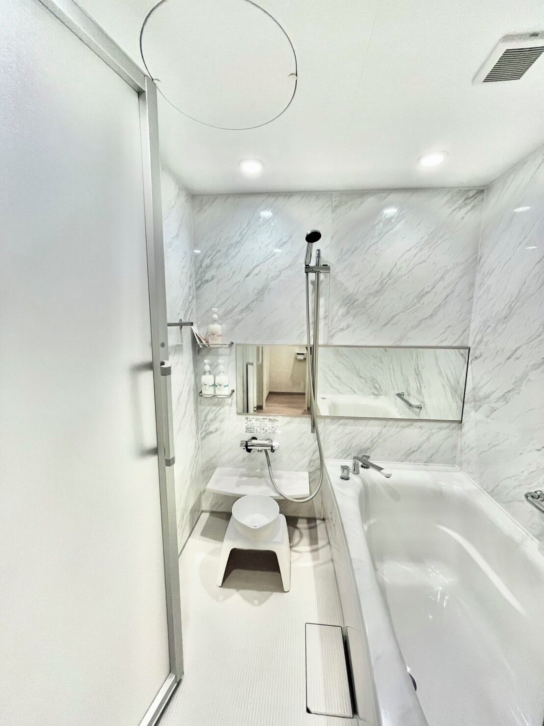 Un baño moderno con una bañera grande, zona de ducha separada y tocador con espejo.