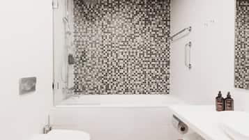 A modern bathroom with a shower, toilet, and sink.
