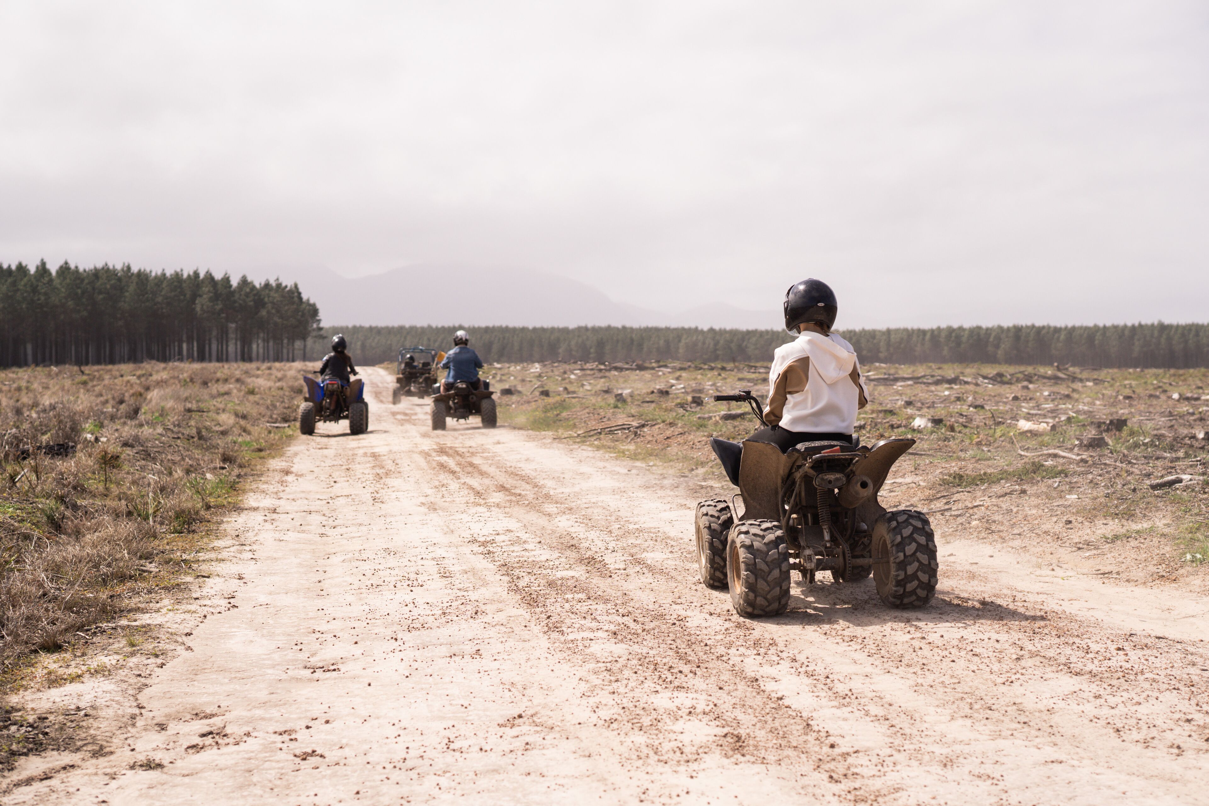 A dirt road with off-road vehicles.