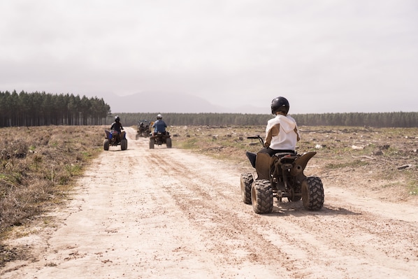 A dirt road with off-road vehicles.