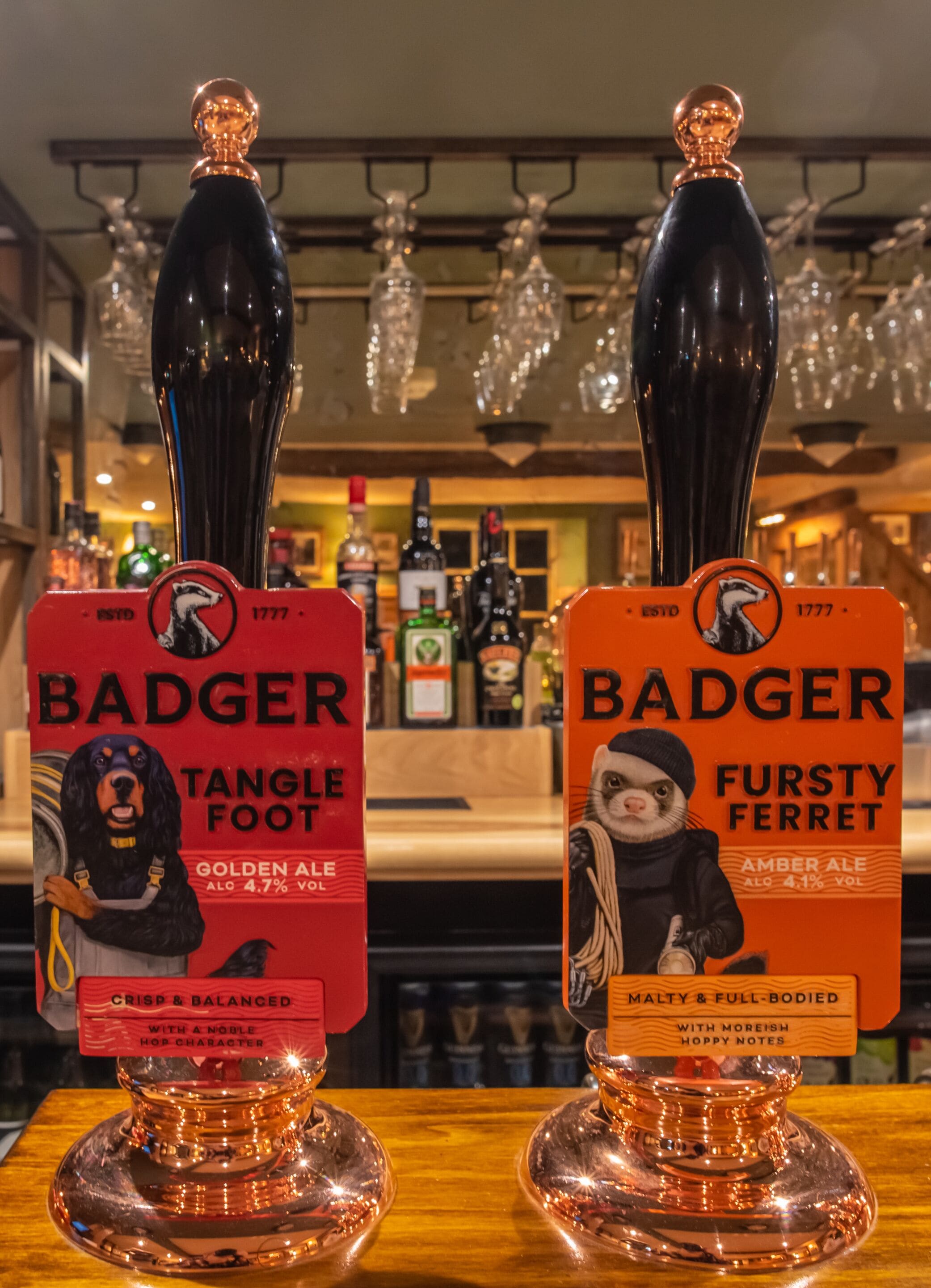 Two beer taps labeled 'BADGER' with distinct labels for 'Tangle Foot' and 'Fursty Ferret' beers.