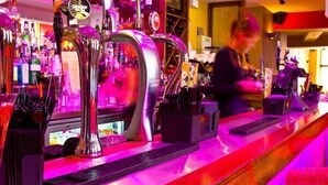 A bar with multiple taps and a bartender preparing drinks. - The Lounge Hotel and Bar (Penrith)