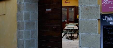 An archway leading to a building with a 'Bistro' sign.