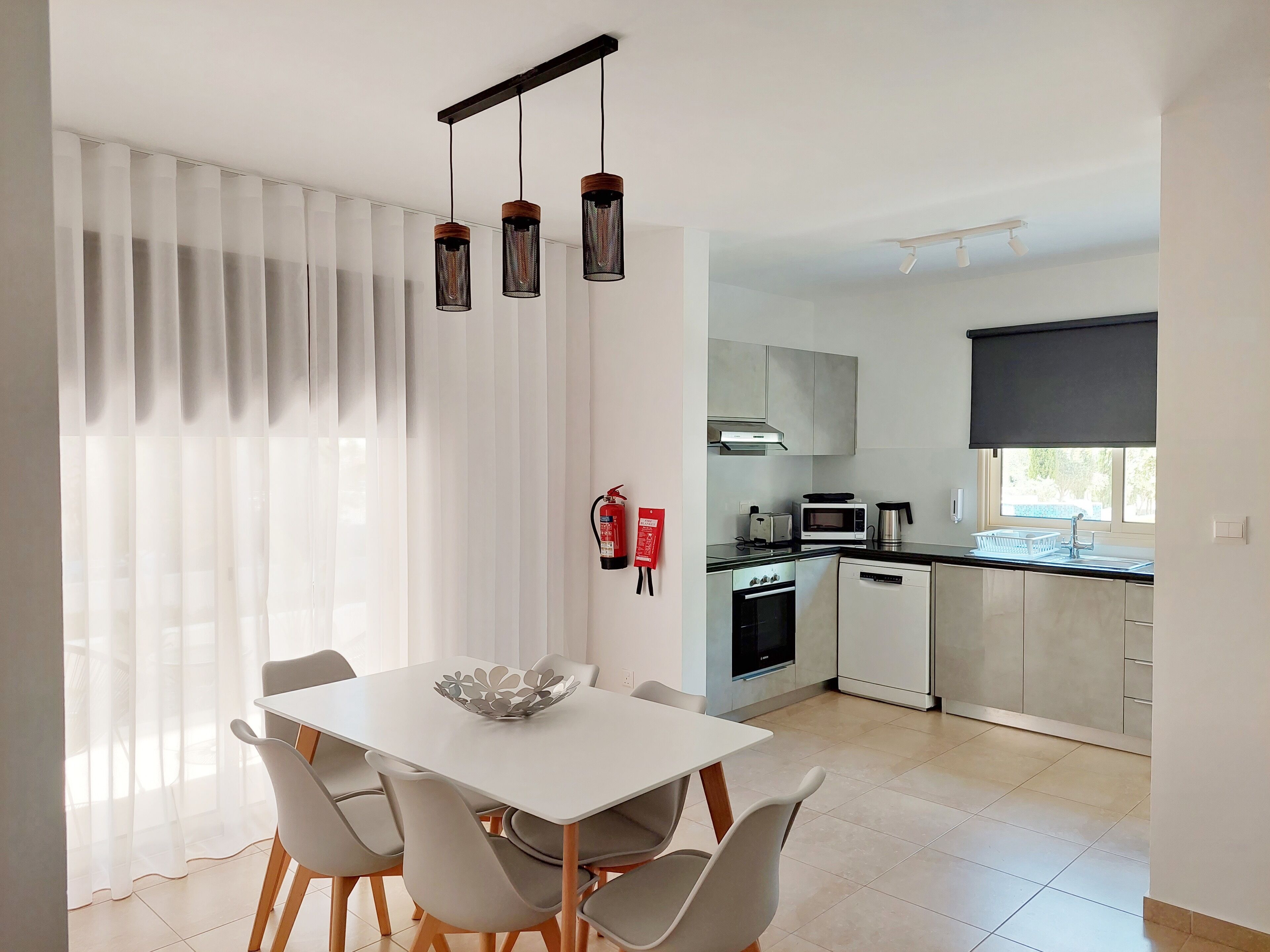 A modern kitchen with a dining area.