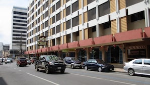 A multi-story hotel with a modern facade, featuring a prominent sign for the Kosit Hotel.