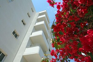 A multi-story building with balconies and windows.