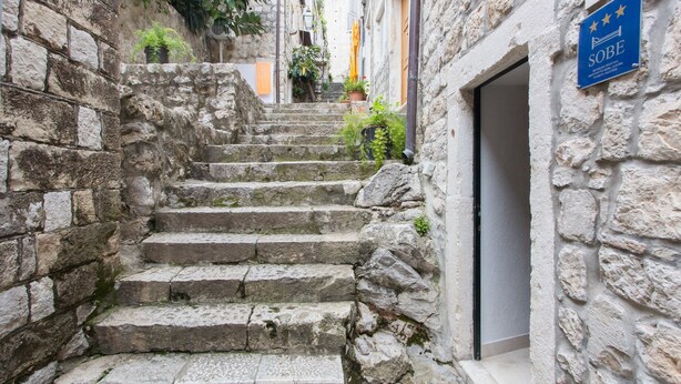 A stone staircase leading to a door with a sign indicating a hotel named "SOBE". - Apartments Ivana (Dubrovnik)