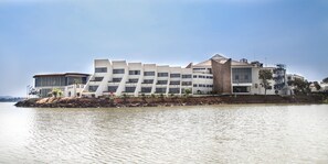 A modern hotel with a waterfront view, featuring a unique architectural design with multiple levels and a prominent central tower. - Blue Nile Resort (Bahir Dar)