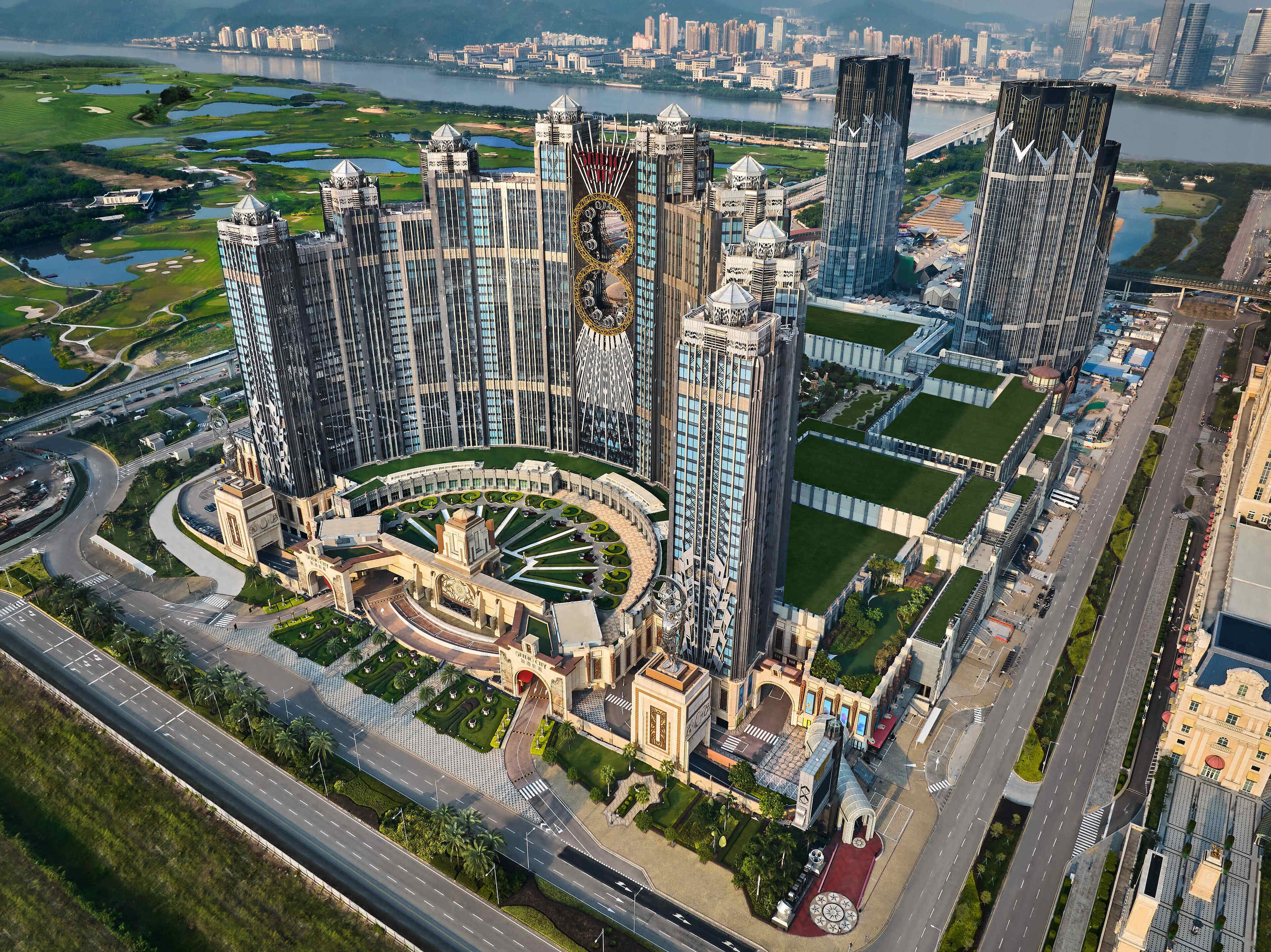 A high-rise building complex with a central courtyard, surrounded by roads and greenery.