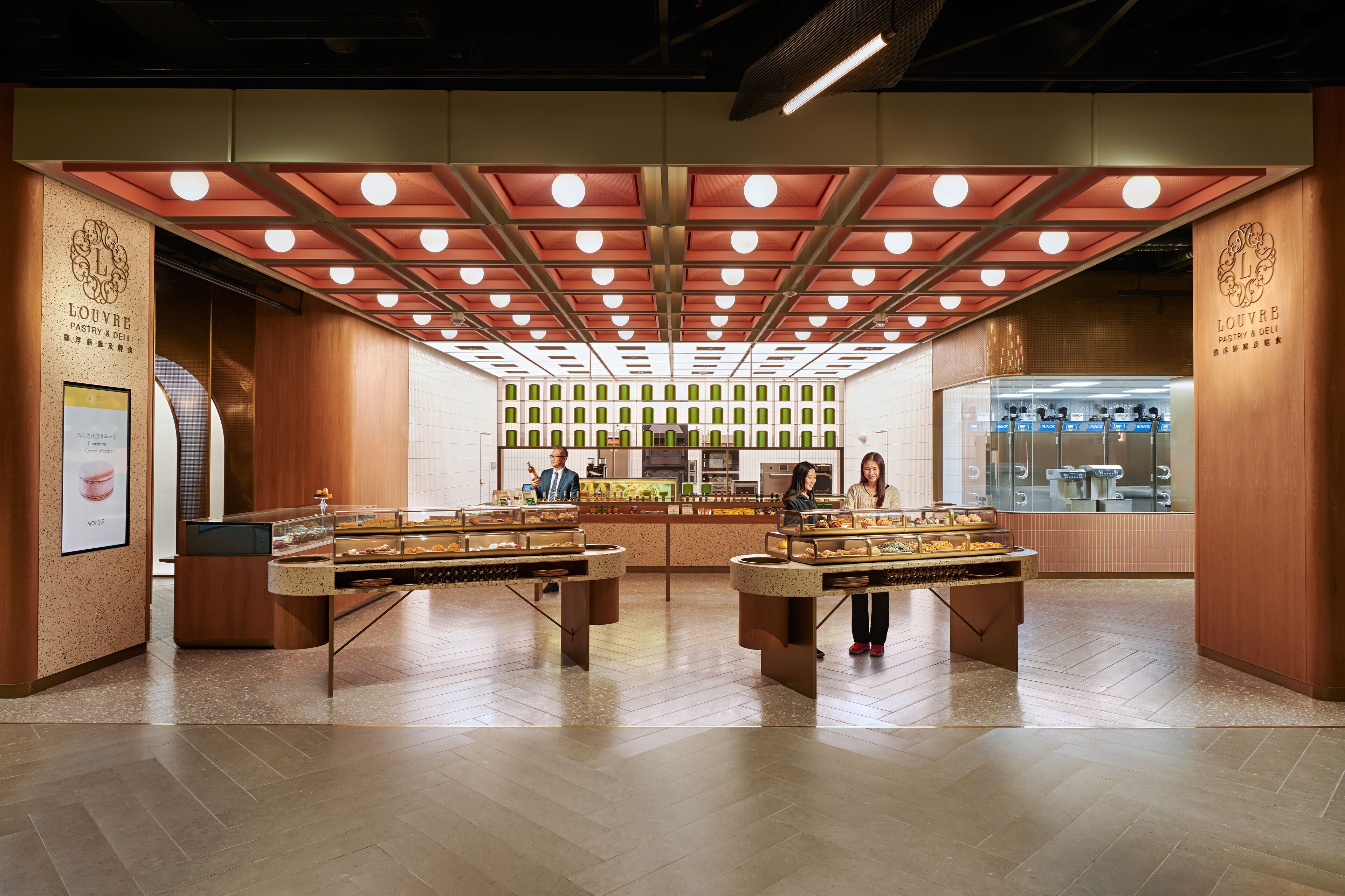 A bakery with a modern design, featuring a central display counter and a refrigerated display case.
