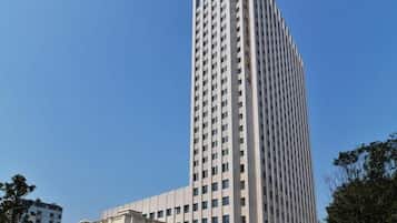 A tall, modern building with a symmetrical facade and a central entrance.