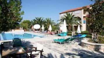 Outdoor pool, open 10:00 AM to 7:00 PM, pool umbrellas, pool loungers