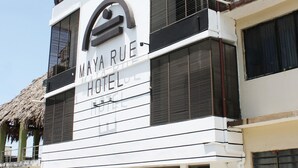 A modern hotel with a prominent sign reading "MAYA RUE HOTEL". - Hotel Maya Rue (Palenque)