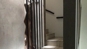 A staircase with a handrail and a door leading to another room. - Hotel Maya Rue (Palenque)