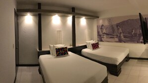 A hotel room with two beds, a large wall-mounted TV, and a painting of a historical scene. - Hotel Maya Rue (Palenque)