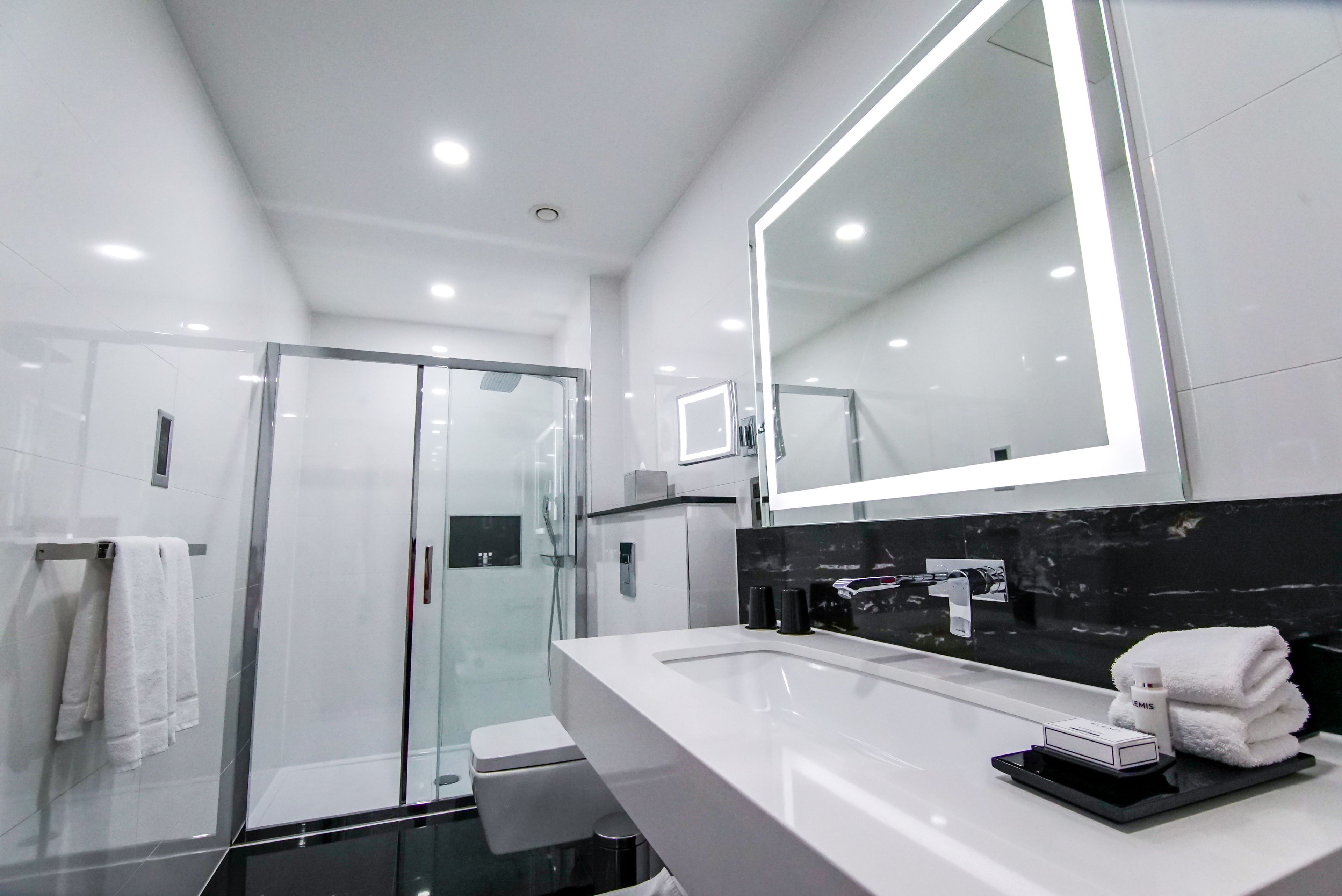 deluxe double or twin room | bathroom | designer toiletries, hair dryer, slippers, towels