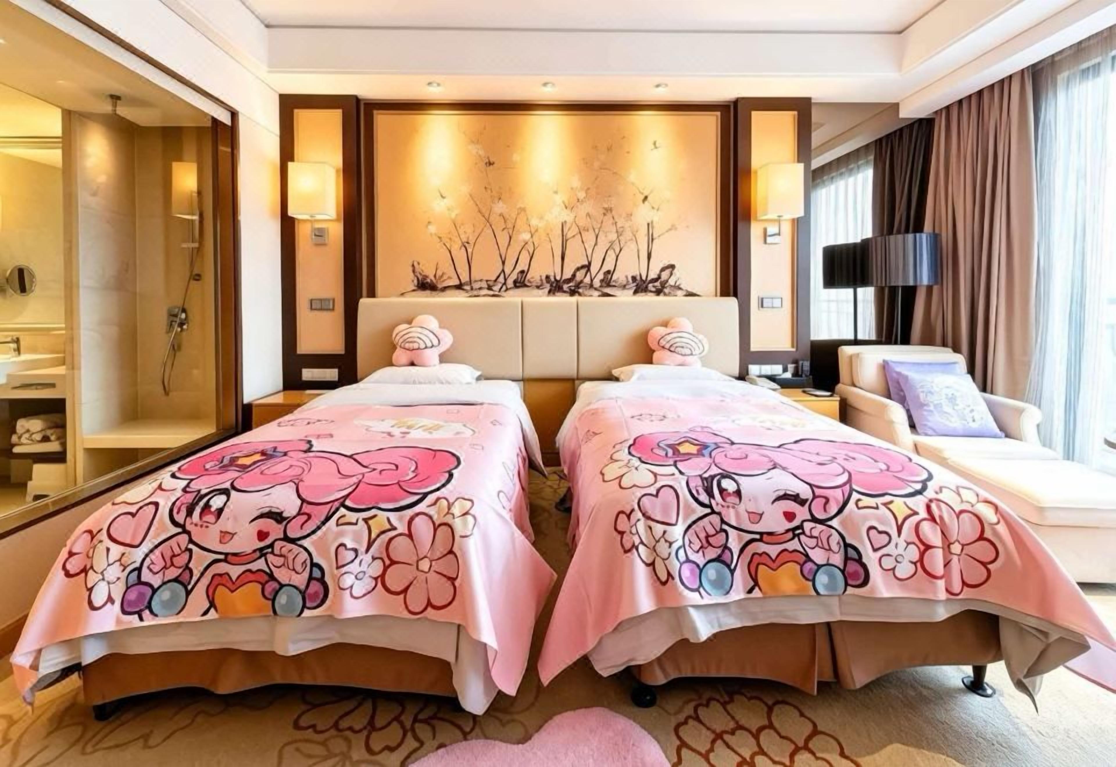 A hotel room with two beds, a sofa, a massage table, and a large mirror.