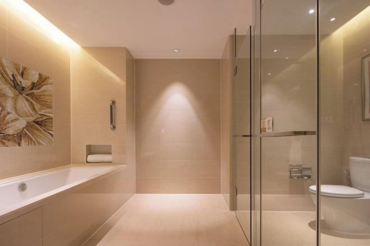 Une salle de bain moderne avec une douche à parois de verre, une baignoire et des toilettes.