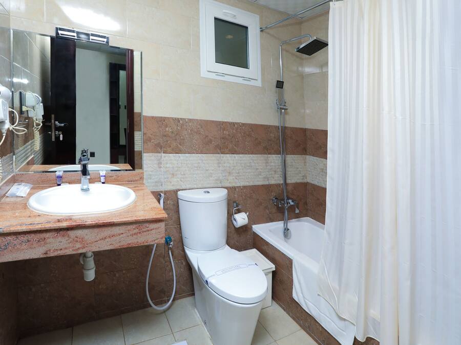 A bathroom with a sink, toilet, and shower.